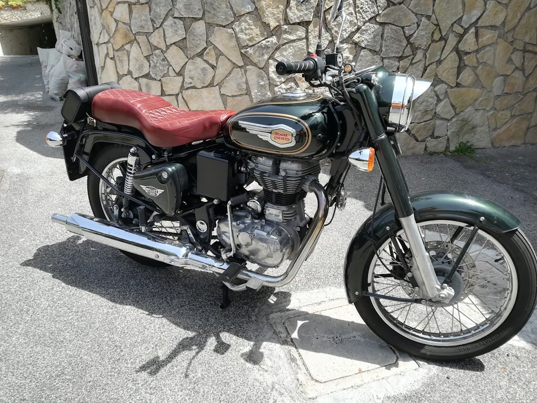 a motorcycle parked next to a stone wall