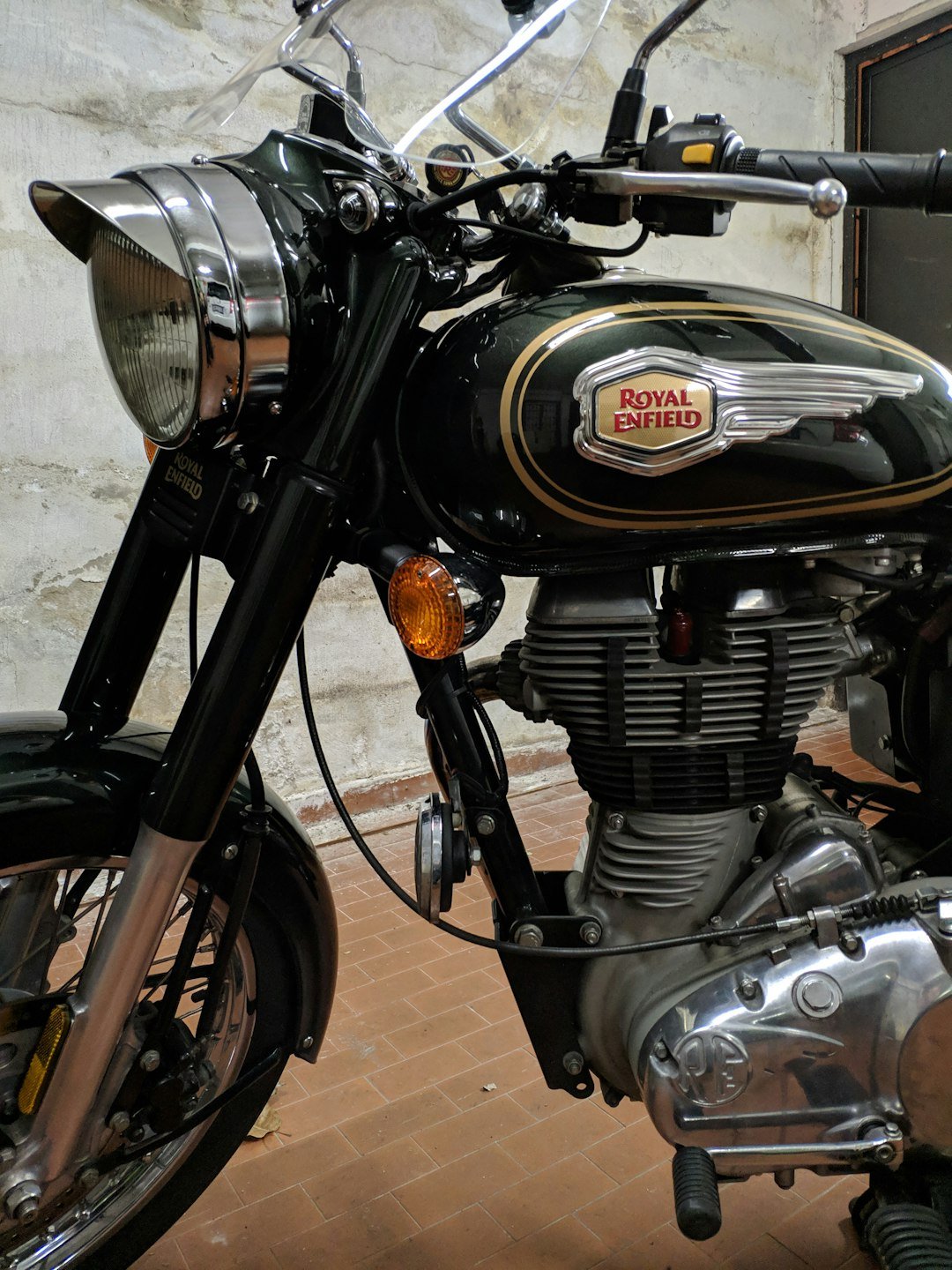 a black and gold motorcycle parked in front of a building