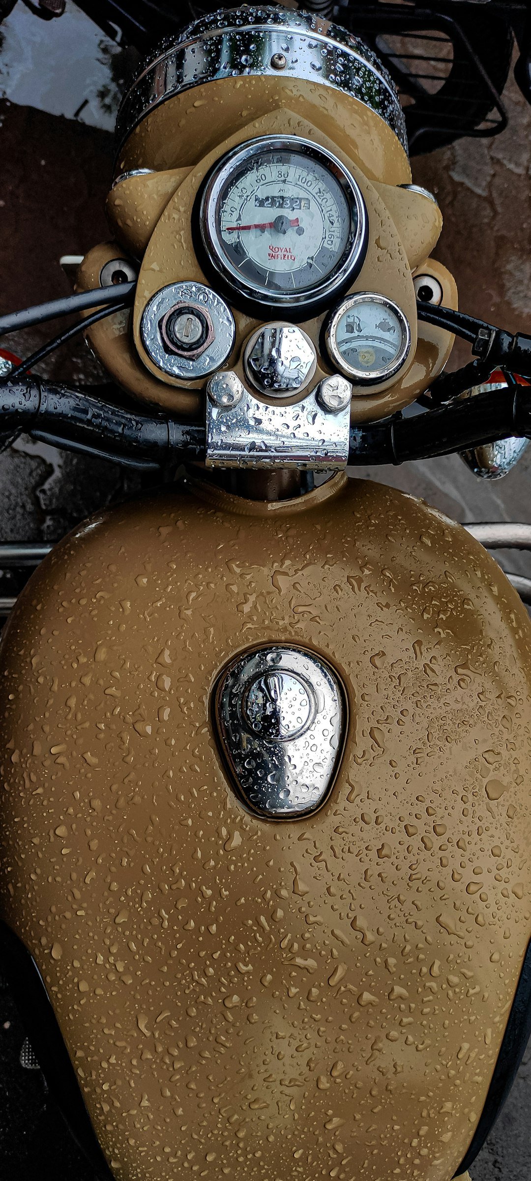 a close up of a motorcycle with water droplets on it