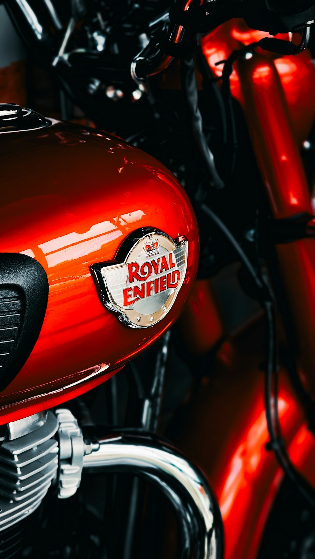 A red motorcycle with a royal enfield sticker on it