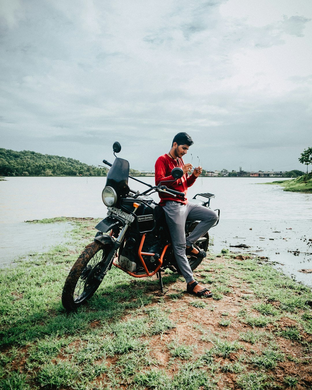 man and woman riding motorcycle on seashore during daytime