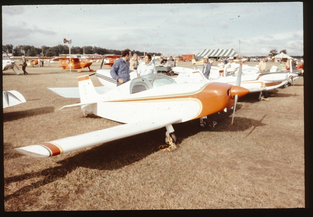 A group of people standing around a small airplane