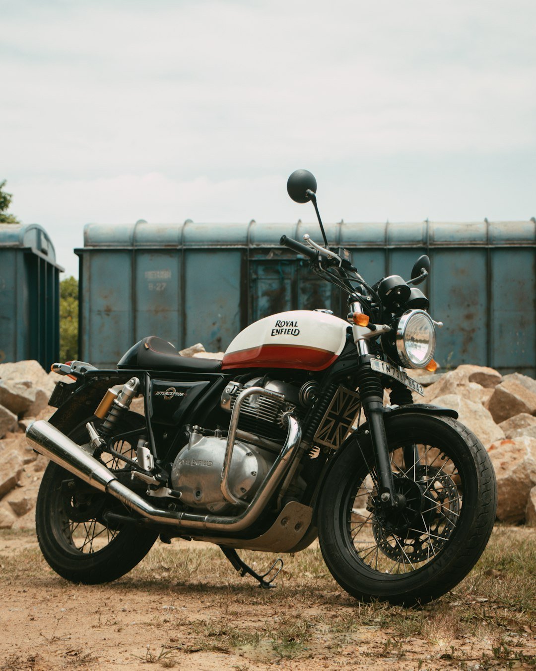 A motorcycle is parked on a dirt road