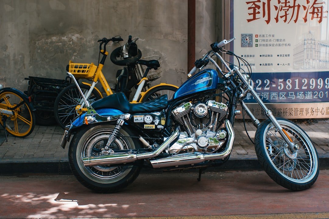 A blue motorcycle parked in front of some bikes.