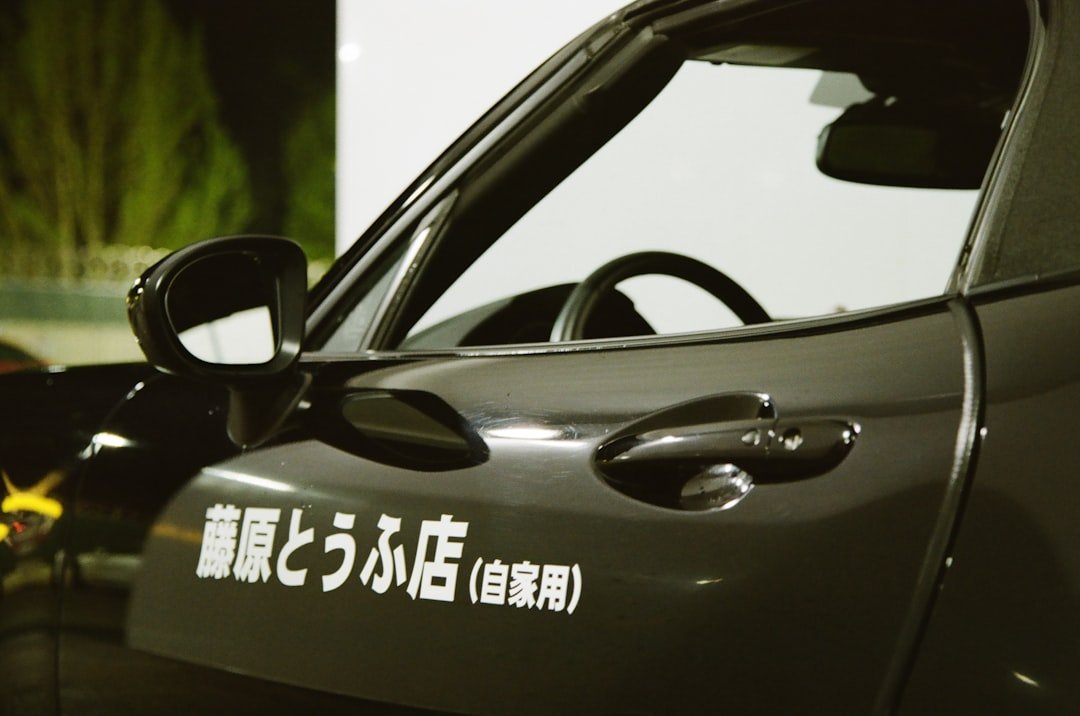 A black car with japanese lettering on it.