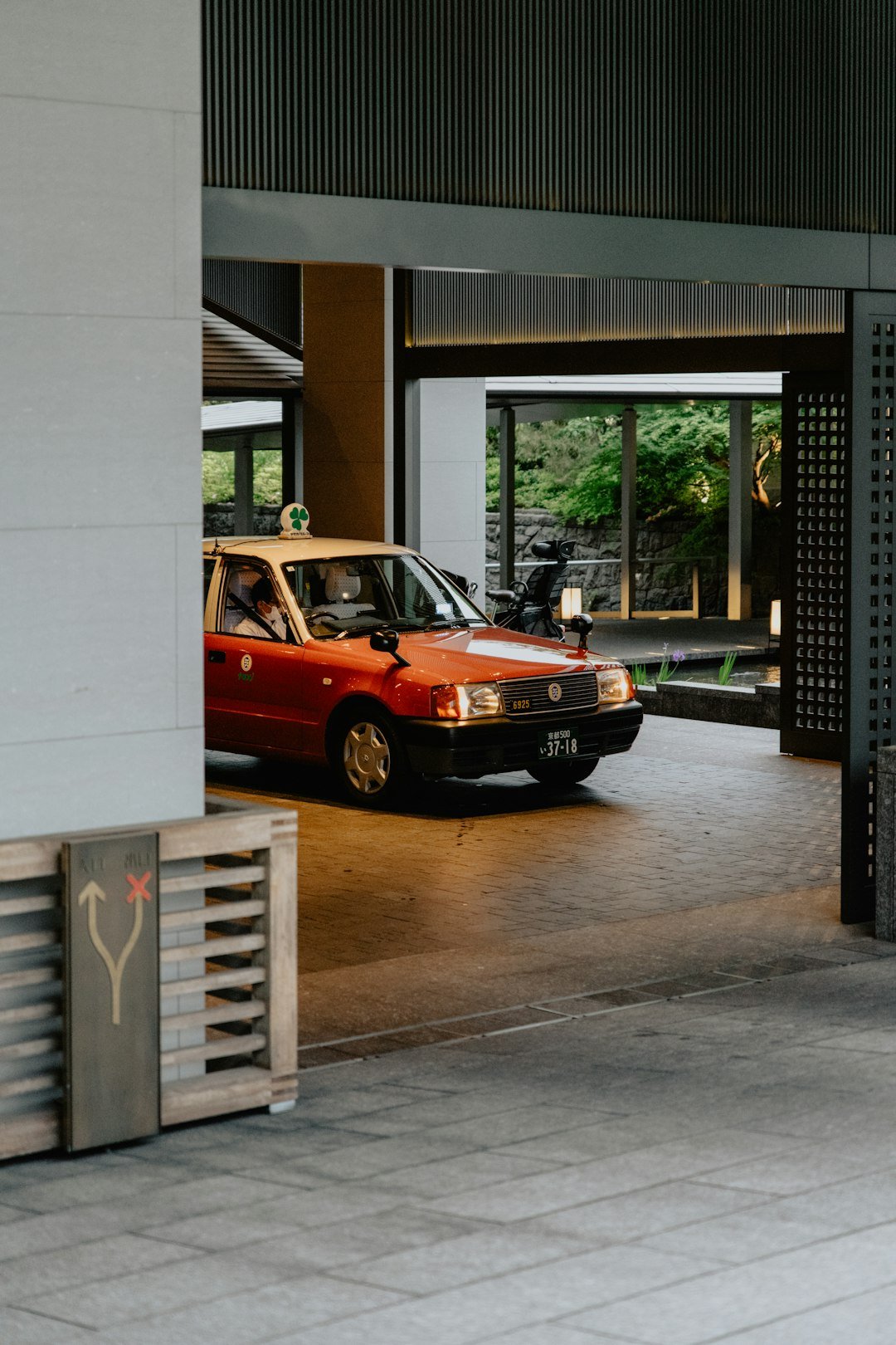 a red car is parked in a parking garage