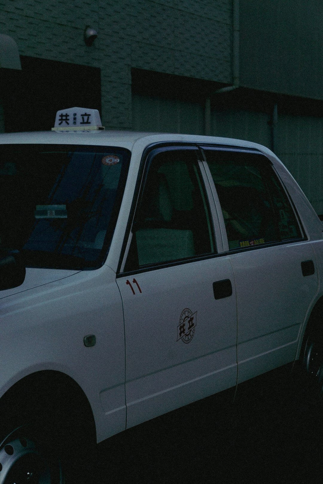a white police car parked in front of a building