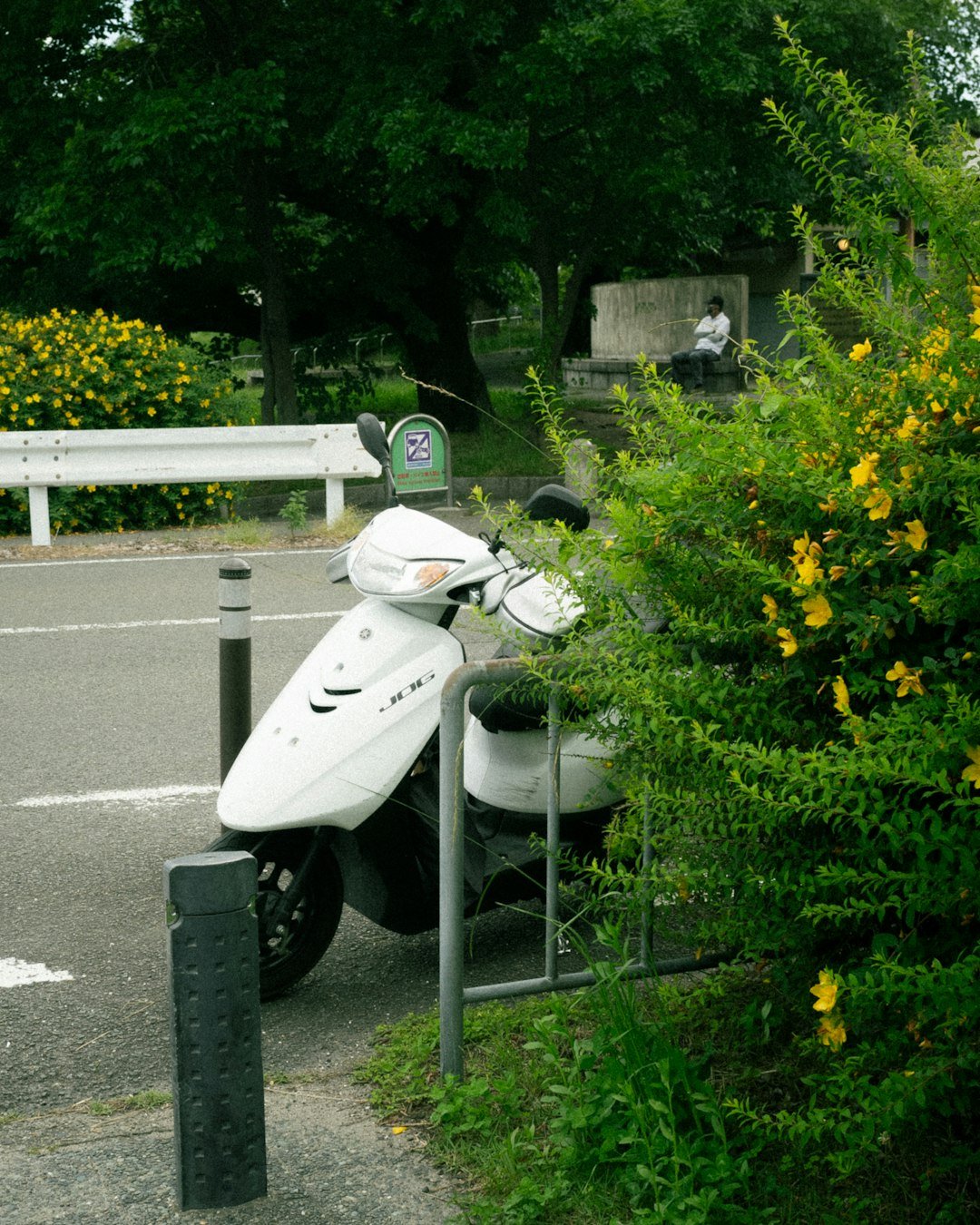 A motor scooter is parked in a parking lot