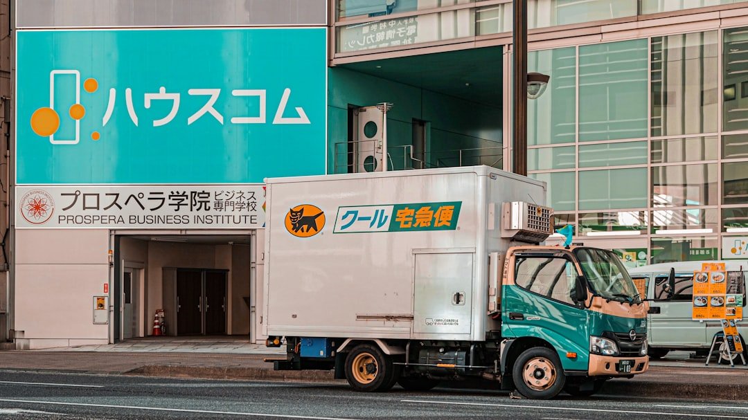white and blue box truck on road during daytime