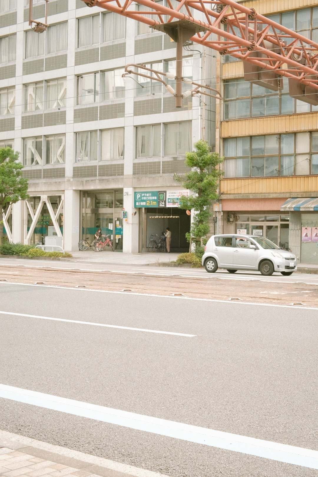 a white van parked in front of a tall building