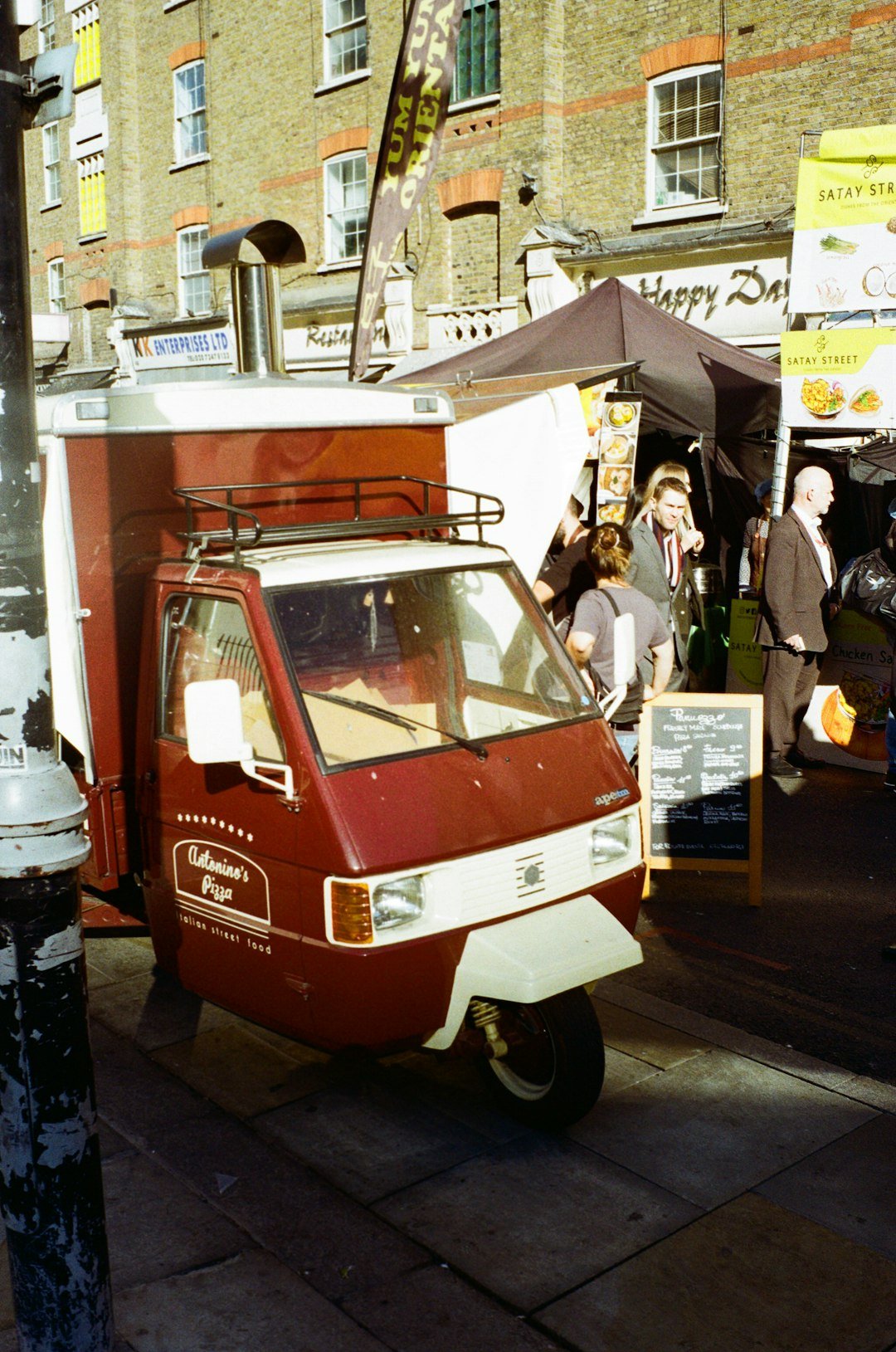 a small red van parked on the side of a street