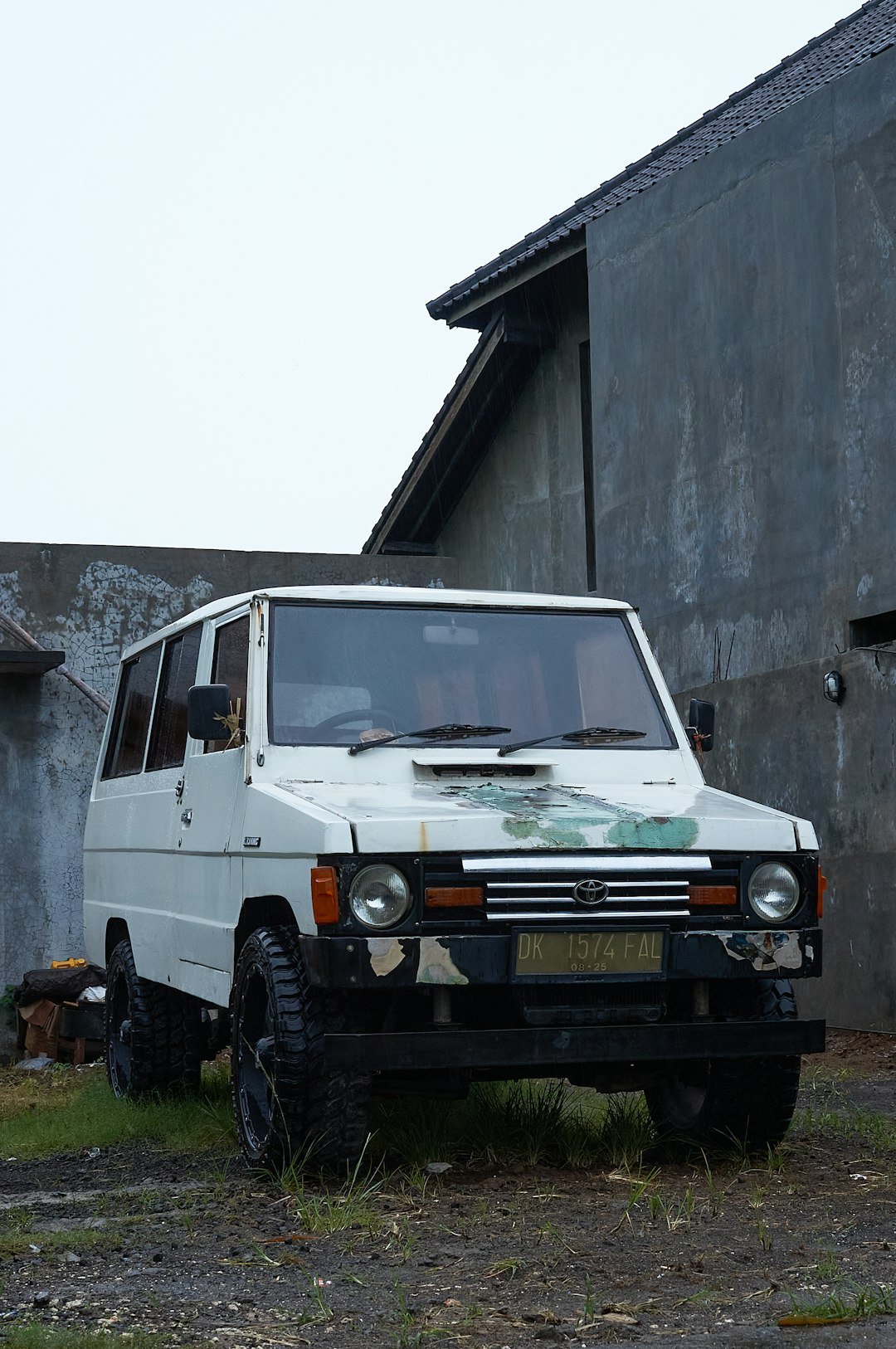 A white van parked in front of a building