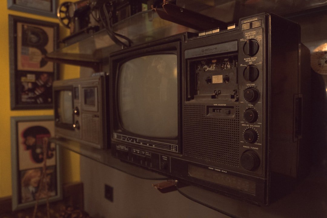 an old tv sitting on top of a shelf