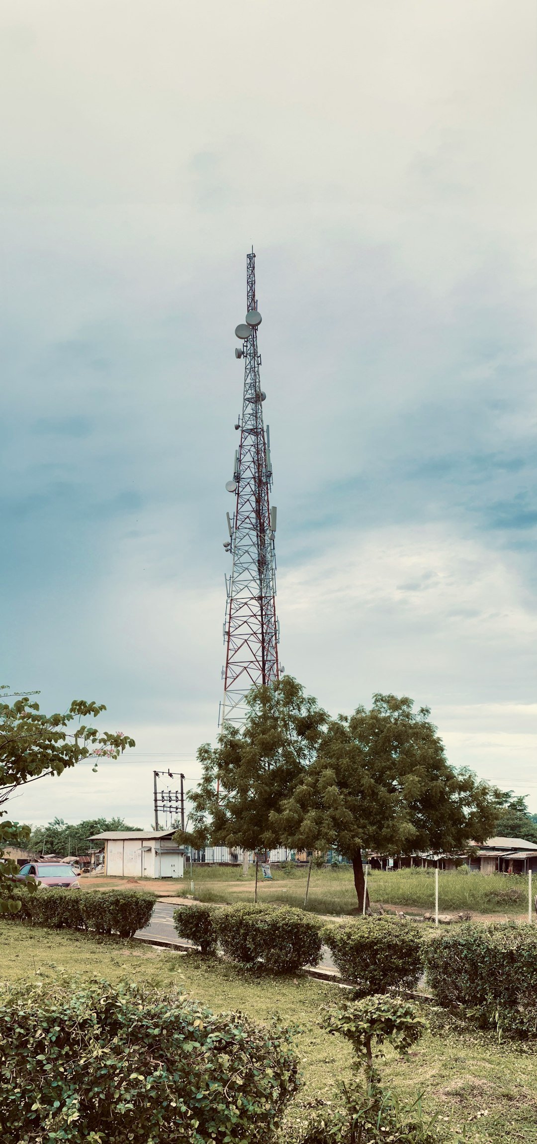 a very tall tower sitting in the middle of a field