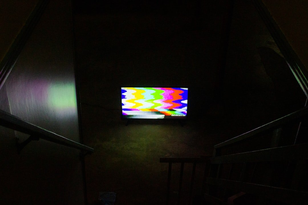 black flat screen tv turned on displaying soccer game
