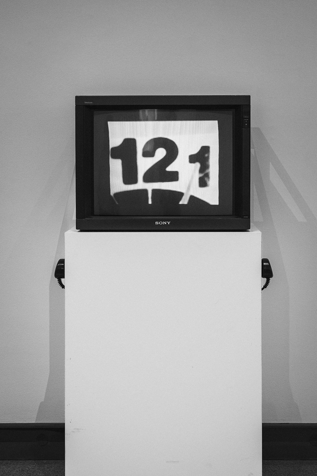 Television displays the number 121 on a pedestal.
