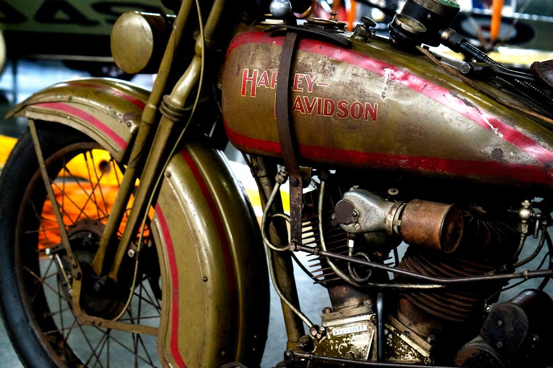red and black motorcycle near yellow car