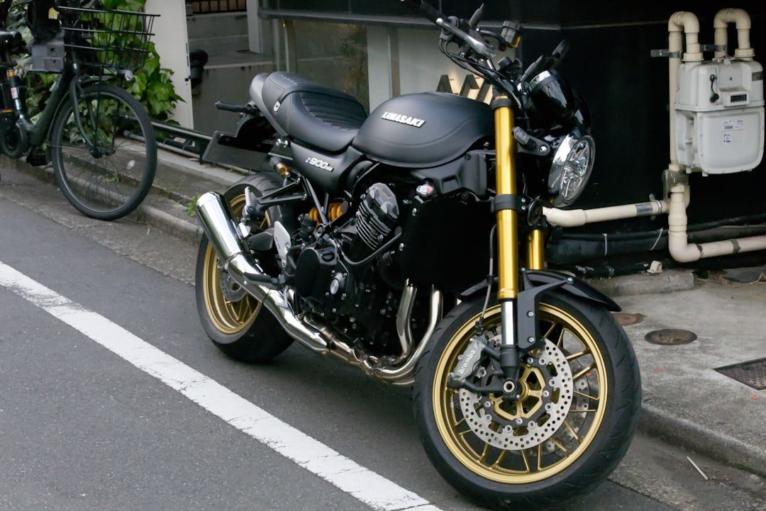 A black motorcycle is parked on a street.