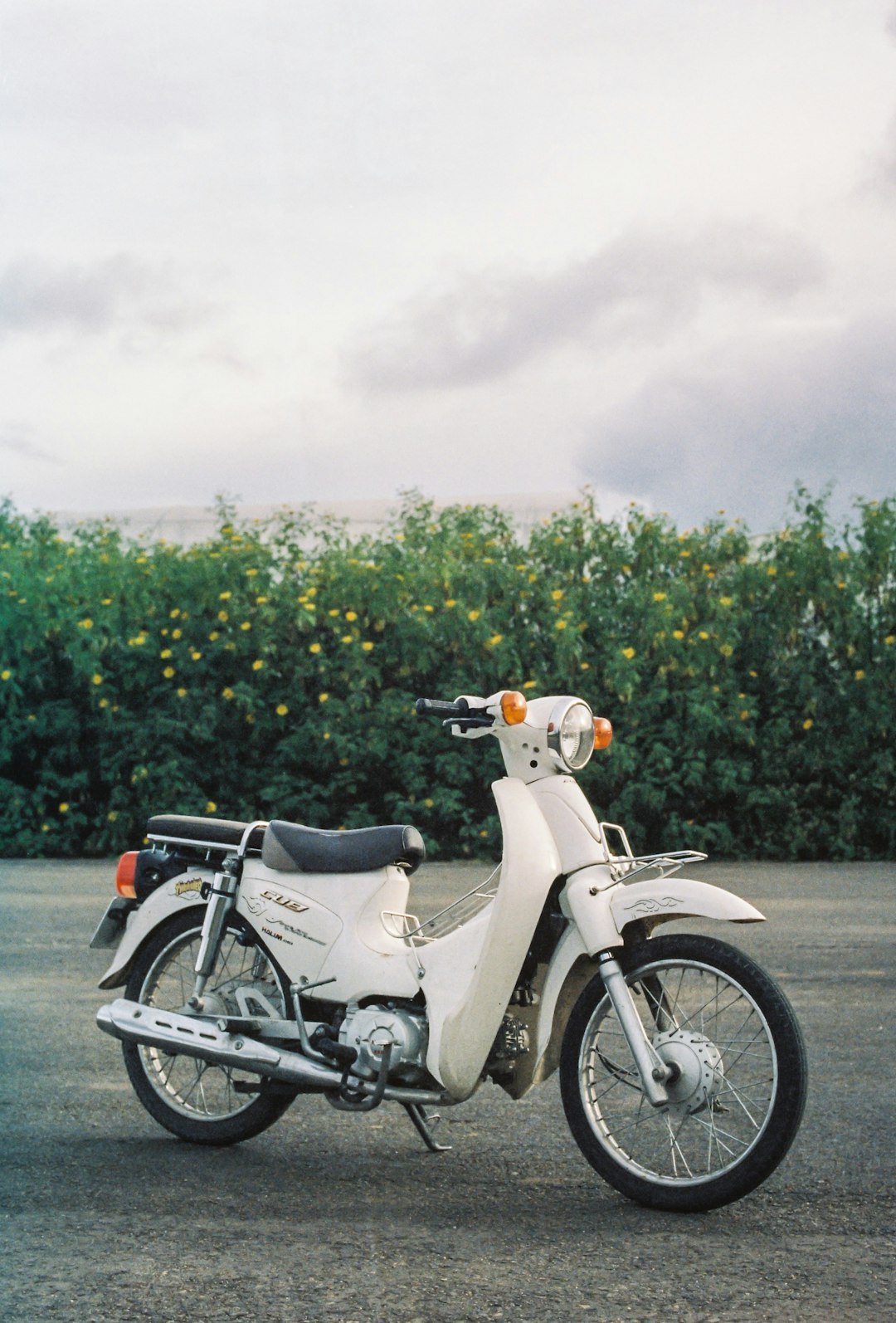 a white motorcycle parked in a parking lot