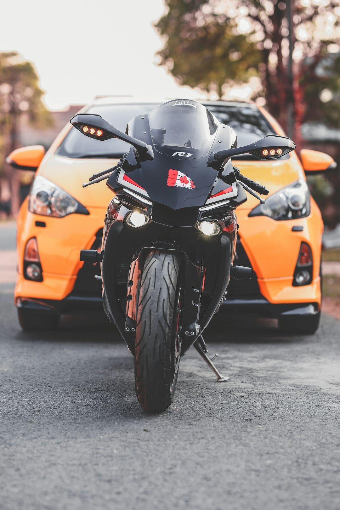 a motorcycle parked next to a car on a street