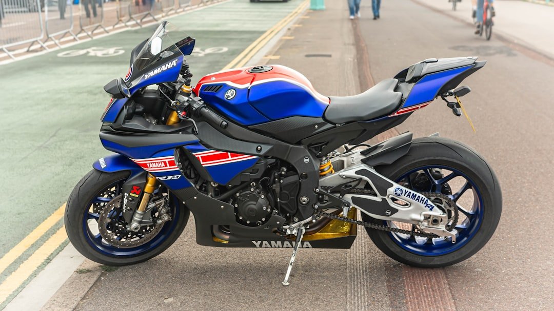 a blue and red motorcycle parked on the side of the road