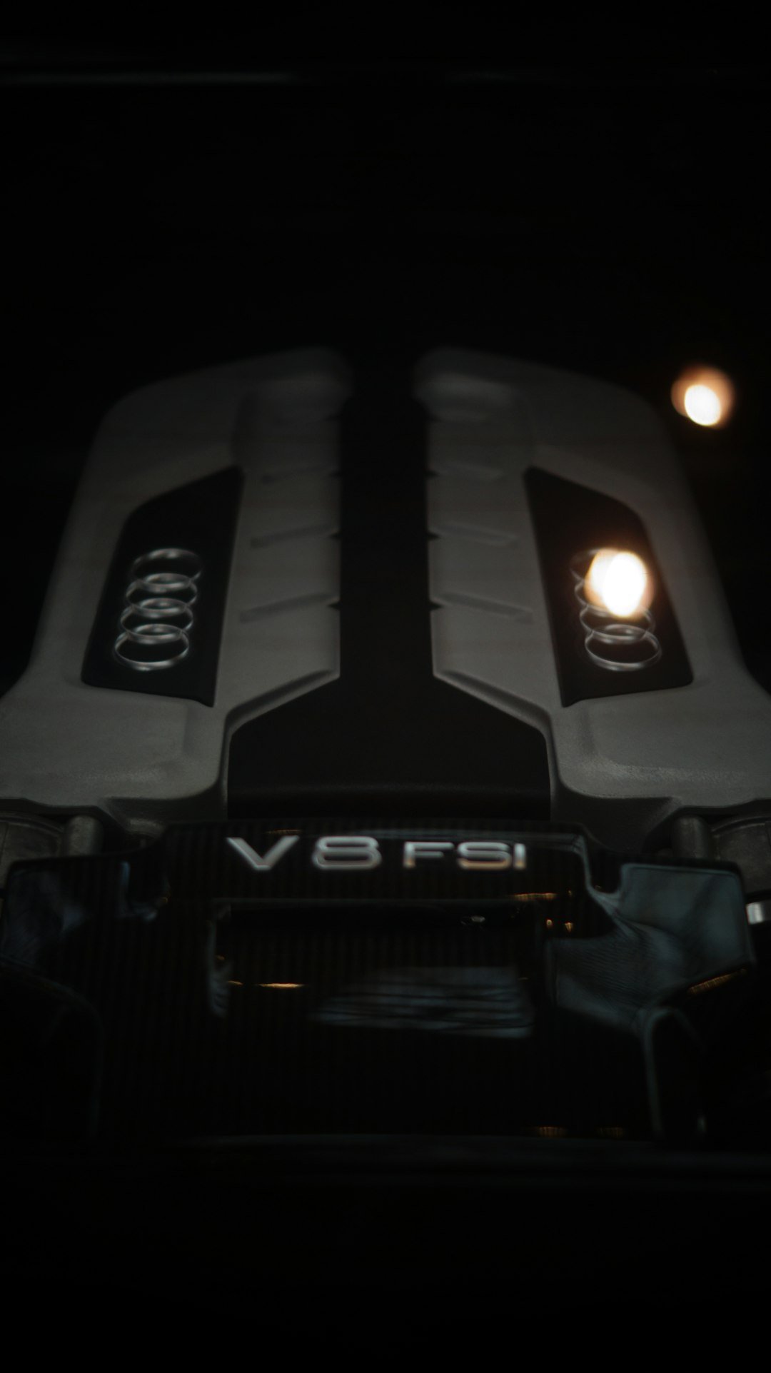 A close up of a car engine in the dark