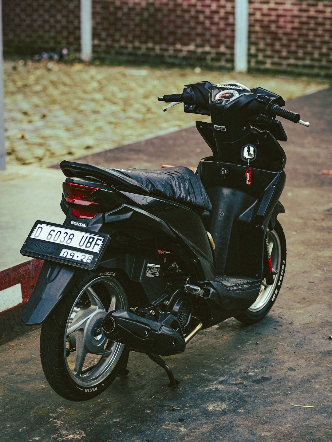 a black motorcycle parked in a parking lot